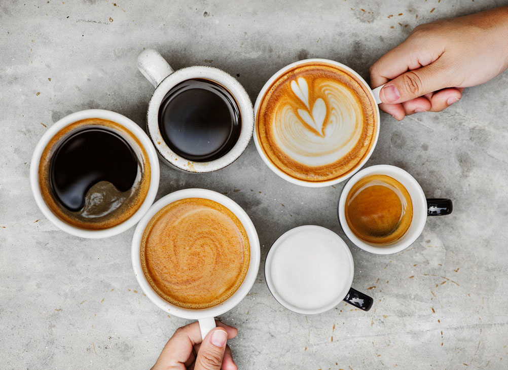 Health benefits of drinking coffee Six different cups of coffee on a table as seen from above