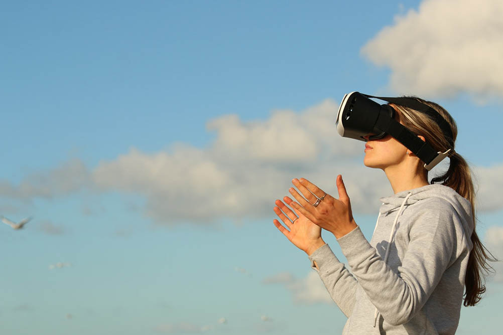 How New Technology is Changing Lotteries for the Better Woman wearing VR glasses outside to play a game