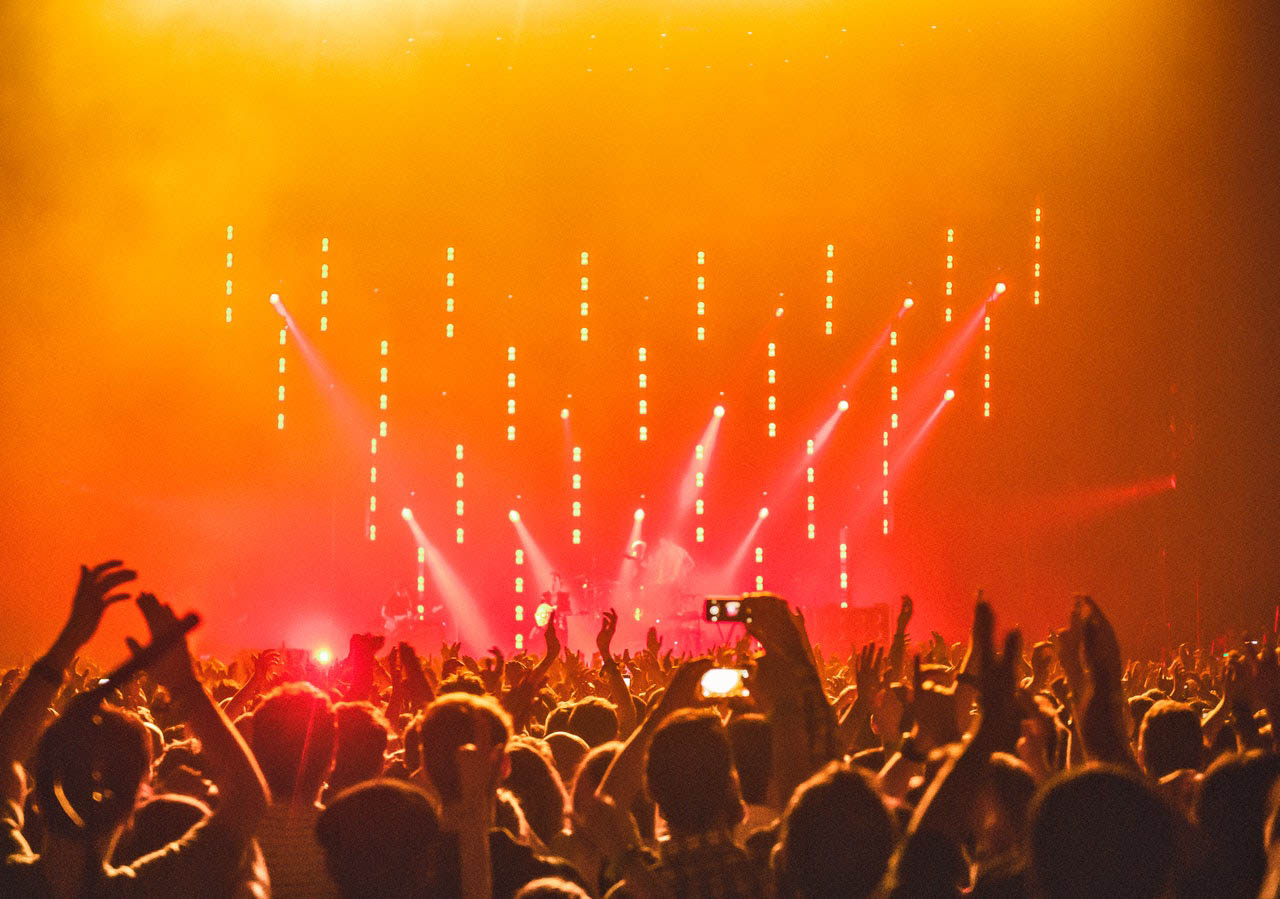 Excited crowd at a rock concert in Canada put their hands in the air